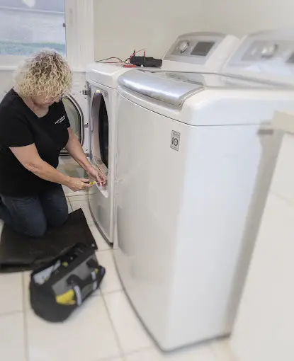 Fast Repairs technician, Mona, repairing a dryer.