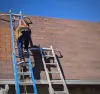 Fast Repairs (Michael) repairing roof on a barn in Sevier County